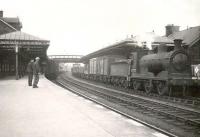 Platform scene at Dumfries on 18 April 1949 as ex-Caledonian 0-6-0 57573 passes through with an up goods train.