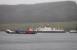 <I>MV Red Baroness</I>, a versatile landing-craft design operated by Troon Tug Co Ltd (a sort of modern day <I>Clyde Puffer</I>), makes its way through the Kyles of Bute with a cargo of fish farm supplies on a dreich 3rd April 2018. In the background <I>MV Loch Dunvegan</I> is at Rhubodach about to return to Colintraive.<br><br>[Mark Bartlett 03/04/2018]