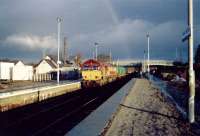 Southbound oil empties from Lairg pause at Muir of Ord for northbound passenger train.<br><br>[Ewan Crawford //]