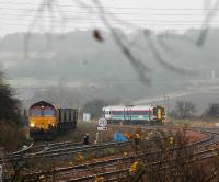 Coal train being loaded at Inverkeithing Central Junction passed by passenger train on west to south curve.<br><br>[Ewan Crawford //]