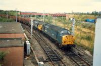 Coming off the R&C at Whifflet North Junction is a Hunterston to Ravenscraig iron ore train. In the background is the closed Whifflet Upper station, although the line was still open to Imperial Works at the time.<br><br>[Ewan Crawford //1987]