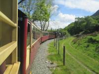 <h4><a href='/locations/W/Waunfawr'>Waunfawr</a></h4><p><small><a href='/companies/N/North_Wales_Narrow_Gauge_Railway'>North Wales Narrow Gauge Railway</a></small></p><p>Welsh Highland Railway train returning from Caernarfon to Porthmadog Harbour, seen in typical Snowdonia scenery, to the south of Waunfawr on 22nd May 2016. 7/10</p><p>22/05/2016<br><small><a href='/contributors/David_Bosher'>David Bosher</a></small></p>