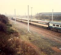 Southbound express passing Shieldmuir Yard. The steelworks in the background only provided scrap for Ravenscraig by this date. Now the site of a Post Office depot.<br><br>[Ewan Crawford //1988]