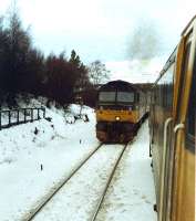Southbound train passing a stopped nortbound train at Tomatin.<br><br>[Ewan Crawford //1989]