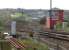 Looking south over Larbert Junction in April 2006. The Edinburgh line turns off to the left towards Carmuirs East Junction, while the Glasgow line continues down the bank past Carmuirs West box (in the distance) before passing below the Forth and Clyde Canal. The Falkirk Wheel dominates the background.<br><br>[John Furnevel 26/04/2006]