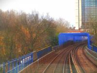 <h4><a href='/locations/W/Westferry'>Westferry</a></h4><p><small><a href='/companies/B/Blackwall_Railway'>Blackwall Railway</a></small></p><p>View from DLR unit no. 72 with a diverted working from Bank to Stratford on the afternoon of Saturday, 3rd December 2022, nearing Westferry along the former London & Blackwall Railway viaduct of 1840, at the point where it crosses the Limehouse Cut, a short canal that links the lower reaches of the river Lea with the Thames and dating from 1769. Closed to passengers in 1926 and to freight in 1962, the viaduct lay disused until utilised by the DLR in 1987 and is now a Grade 1 Listed Structure by English Heritage. 42/46</p><p>03/12/2022<br><small><a href='/contributors/David_Bosher'>David Bosher</a></small></p>