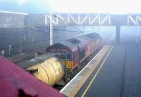 An early morning mist covers Carstairs on 6 June 2006, as a freight passes through the station on its way north hauled by EWS 66216.  <br><br>[John Furnevel 06/06/2006]