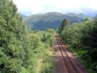 Crianlarich Lower Junction looking east. On the left is the (very overgrown) cut-back line to Callander and to the right the WHL link to the Oban line. The line on the left may re-open to Crianlarich Lower for timber traffic.<br><br>[Ewan Crawford 01/07/2006]