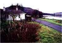 View looking north west over Cambusavie Halt, level crossing and crossing keepers house.<br><br>[Ewan Crawford //]