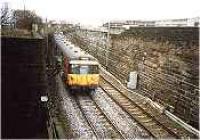 Class 303 on the Glasgow City and District Railway crossing bridge over the Glasgow Central Railway.<br><br>[Ewan Crawford //]