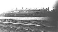 Men handling an enormous tree in the sidings at the now closed Gargunnock station.<br><br>[John McLaren Collection //]