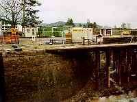 Looking east towards Fort Augustus station where the Caledonian Canal was crossed via a swing bridge by the Fort Augustus Pier branch. The canal is drained for annual maintenance in the view.<br><br>[Ewan Crawford //]