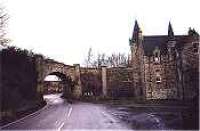 Looking north at the gatehouse to Castle Grant which incorporated a railway bridge and Castle Grant platform.<br><br>[Ewan Crawford //]