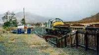 Class 37 hauled ballast train running east through Strathcarron station.<br><br>[Ewan Crawford //]