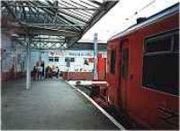 Largs station, under glass canopy, looking north. Class 318 in station.<br><br>[Ewan Crawford //]