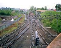 View looking west from Gartsherrie Road over Sunnyside Junction in 1987. The line running off to the south is the freight only link to Whifflet South Junction. The line turning north under the bridge alongside the signal box latterly served Gartsherrie cement works and Gunnie Yard. The land beyond the fence on the left is part of Summerlee Heritage Museum.<br><br>[Ewan Crawford //1987]