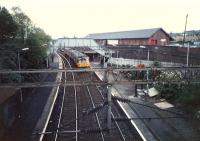 Looking west at Neilston station with a class 303 from nearby roadbridge.<br><br>[Ewan Crawford //1987]