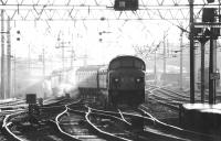 A down train approaching Carlisle platform 3 out of the sun on a bright June afternoon in 1976 behind Holbeck 'Peak' type 4 locomotive no 28.<br><br>[John Furnevel 27/06/1976]