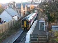 The mini-platform at Beauly in November 2003. The original 1862 station building and fenced off up platform can be seen on the left. The old station closed to passengers in June 1960 but reopened in April 2002 using the new short platform arrangement.   <br><br>[John Furnevel 22/11/2003]