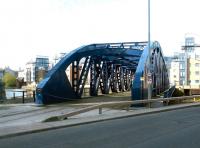 The Victoria swing bridge in Leith Docks, still surviving with rails in place amongst the new riverside penthouse flats in April 2004, although now used as a walkway across the Water of Leith.<br><br>[John Furnevel 25/04/2004]