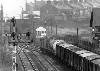 A wet Friday afternoon in July 1969 at London Road Junction, Carlisle, where the N&C and S&C lines leave the city. An eastbound freight arriving from Bog Junction on the goods lines is about to join the main line, with the signal beyond the road bridge indicating a route set for the N&C at Petteril Bidge Junction. The spur from Upperby can also be seen coming in from the right between the signal box and the bridge. The siding running off to the left once served the yard of crane makers Cowans, Sheldon & Co.  <br><br>[John Furnevel 04/07/1969]
