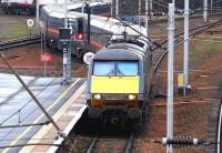 A London - Edinburgh - Glasgow GNER service crosses the up WCML as it snakes through the tight crossover to reach the down line at Carstairs station on 9 December 2004.<br><br>[John Furnevel 09/12/2004]