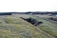 View looking west to Lugar station. This line was to be re-opened to Powharnal (Gaswater). To the left are bings from the Lugar Ironworks.<br><br>[Ewan Crawford 20/02/2004]