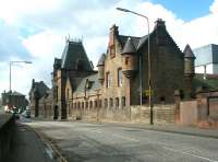 The original (and slightly spooky) refuse disposal works building seen looking west along Broughton Road, Powderhall, in March 2004. The building was originally dubbed <I>The Destructor</I>. Part of the modern waste processing and disposal facilities can just be seen to the rear. The bricked-up gateway in the wall on the right once led down to the platforms of Powderhall station, an area now used as a loading apron and siding by the <I>Binliner</I>. [See image 11948]<br><br>[John Furnevel 22/03/2004]