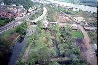 Old Kilpatrick station viewed from the Erskine Bridge. The old station is now partly landscaped. The partly closed oil depot is seen top right. Forth and Clyde Canal on left.<br><br>[Ewan Crawford //]
