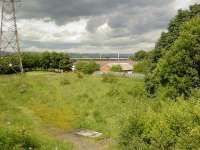 Looking North to site of Ferguslie Station from Paisley Canal Line with Paisley to Ayr line in background.<br><br>[Graham Morgan 26/06/2006]