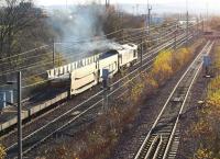 The low Autumn sun catches the afternoon 6M85 Bathgate - Washwood Heath car carrier empties entering Millerhill yard in November 2004 behind a class 60 locomotive.<br><br>[John Furnevel 10/11/2004]