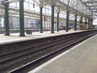 Taken during the renewal work at Glasgow Central, an EWS Class 66 ballast train sits at Platform 3<br><br>[Graham Morgan 23/04/2006]