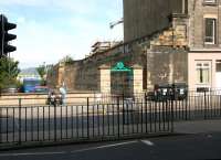 Looking west across Easter Road in 2006 at the remaining bridge abutment and north wall of Leith Central. Platform level was approx 20 feet above the pavement.<br><br>[John Furnevel 22/07/2006]