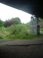 Looking East, this shows the site of Bridge of Weir Station from where Platform 1 stood. The metal pillar was recently erected by the local council to help prop up the road bridge.<br><br>[Graham Morgan 20/07/2006]