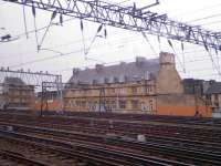 Looking at the offices at Bridge Street where Network Rail have been painting out the vandalism on the walls with orange graffiti resistant paint. <br><br>[Graham Morgan 22/04/2006]