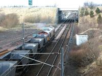 Coal empties restarting northbound from Millerhill yard in February 2002 following a signal check. Newcraighall station is under construction just beyond the bridge and part of what will become the new turnback siding is visible on the left. The new station and siding became operational four months later.<br><br>[John Furnevel 13/02/2002]