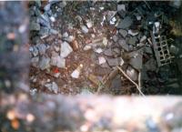 Looking down a ventilation grille to the  inside the passway entrance. The rubble is the demolished station buildings.<br><br>[Ewan Crawford //1987]