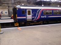 A Class 156 sits at Glasgow Central. The unit is  part of the programme by First to repaint all non SPT liveried stock into its corporate colours.<br><br>[Graham Morgan 05/08/2006]