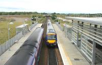 Slow westbound meets fast eastbound. Edinburgh Park, August 2006. The space in the left background has been cleared to make way for a new hotel.<br><br>[John Furnevel 13/08/2006]