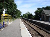 Tain station looking south showing the rennovated station building and new waiting shelter.<br><br>[John Morton /07/2006]