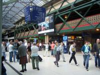 Looking north alongside the walkway which crosses the whole of Waverley at high level. The new foobridge (white) over platform 1 the new Balmoral platform is distant left. Its festival time thus kilts.<br><br>[Ewan Crawford 12/08/2006]