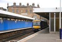 A Fife bound train arrives at Haymarket platform 2 on 5 August 2006. Behind the blue barrier on platform 1 work continues on construction of the new bay platform.   <br><br>[John Furnevel 05/08/2006]