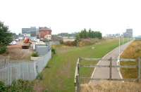 Looking north east towards a misty Firth of Forth from West Granton Road in August 2006. View is along the former Caledonian route (now a walkway), with the trackbed of the line from Pilton West Junction into Granton Gasworks (and station) branching off into the site on the left. In the right background stood Breakwater Junction with the left fork continuing on towards the western breakwater and the right running down to the CR's Granton Goods station [see image 3220].<br><br>[John Furnevel 16/08/2006]
