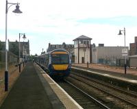 Platform scene at Broughty Ferry on 6 August looking east towards the level crossing. 170402 stands at Platform 2 with the 15:09 Glasgow Queen Street - Aberdeen service. Part of the recent retail development on the south side of the station, together with the refurbished and relocated signal box, can be seen on the right. [See news item].<br><br>[Derek Smart 06/08/2012]