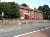 Looking north west across Pollokshaws Road on 11 August 2006 towards the boarded up, yet still imposing, former station building at Pollokshaws West.<br><br>[John Furnevel 11/08/2006]