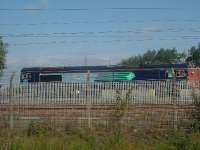 DRS Class 66 66410 collecting freight at WH Malcolms freight terminal at Elderslie for movement to Grangemouth. <br><br>[Graham Morgan 16/10/2006]