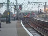 Class 334 Juniper departing Glasgow Central passing by a Class 314 approaching the station with a southbound Virgin Voyager in the background.<br><br>[Graham Morgan 26/08/2006]