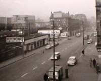 Near Eglinton Street. Nov. 1962. Petrol @ 3/-. A blue train passing the new Central Power Box. Sorry for lack of clarity, but smog, remember that, was the culprit.<br><br>[Brian Forbes /11/1962]