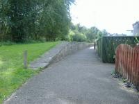 Paved over trackbed and grassed  Platform of Kirriemuir Station... now landscaped as part of local housing path. Not much else remains<br><br>[Colin Harkins 31/08/2006]