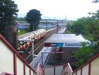 Train for Drumgelloch about to leave Easterhouse in September 2006 and pass below traffic queued on the M8 Motorway.<br><br>[John Furnevel 01/09/2006]